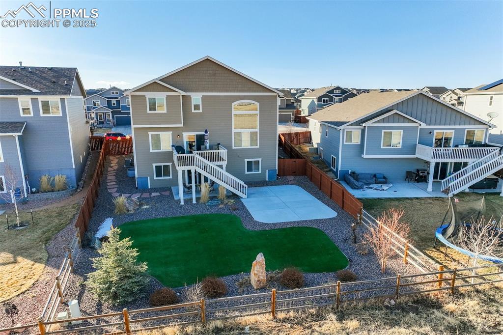 Image 33 of 35: Rear view of property featuring a patio, stairs, a residential view, and a 