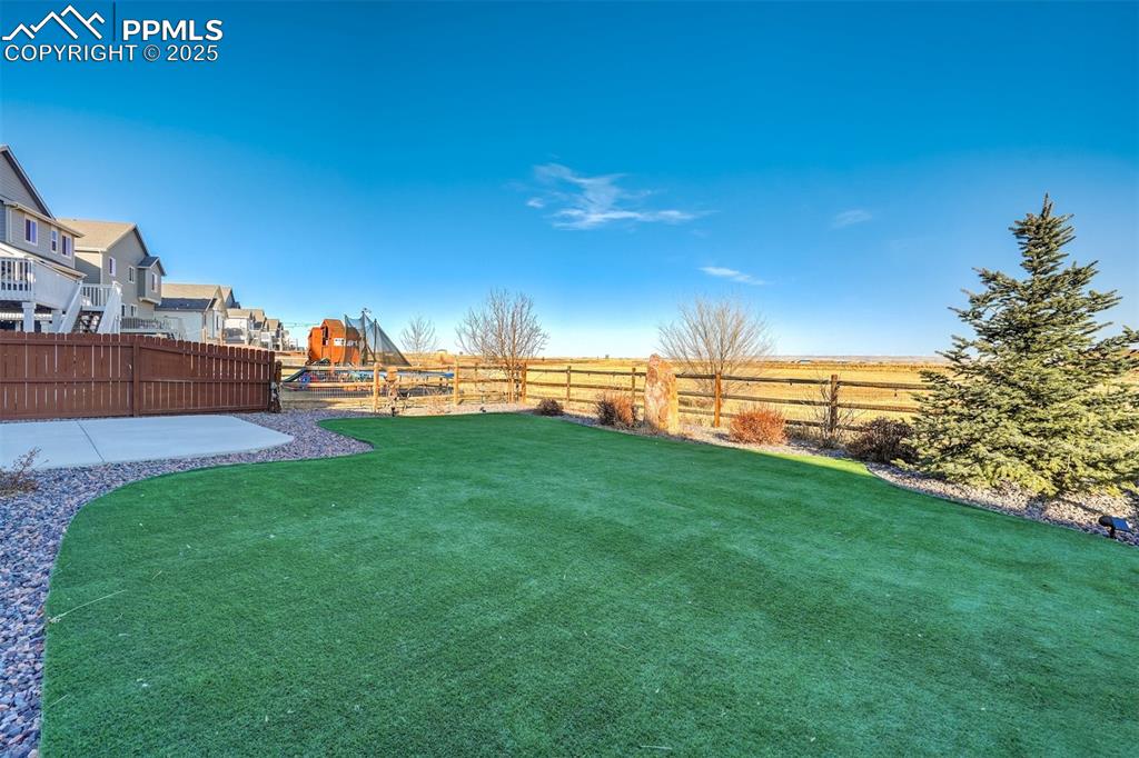 Image 34 of 35: View of fenced backyard