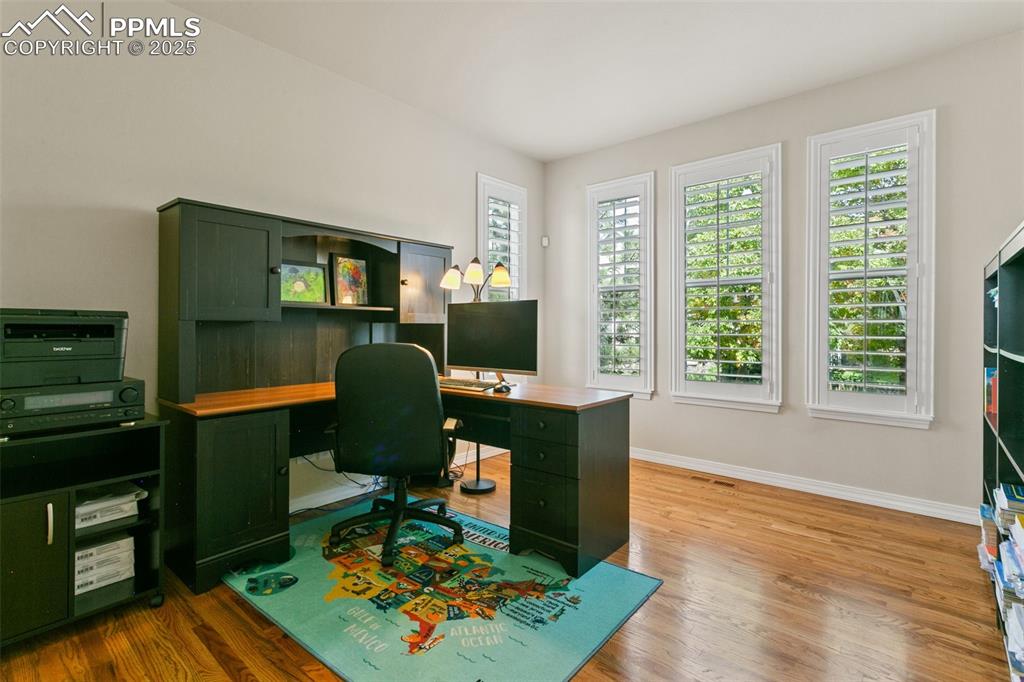 Image 17 of 37: Office space featuring light wood finished floors and baseboards