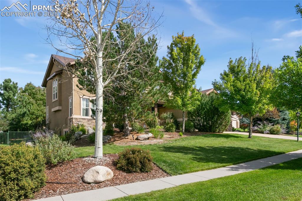 Image 2 of 37: Craftsman inspired home featuring stucco siding, a garage, concrete drivewa