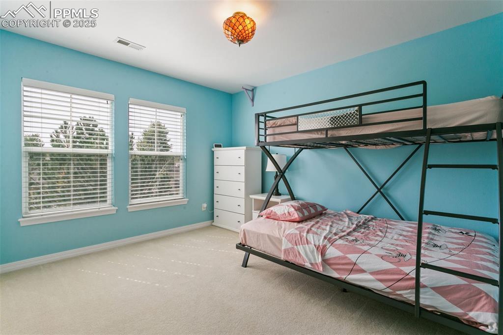 Image 24 of 37: Carpeted bedroom featuring baseboards