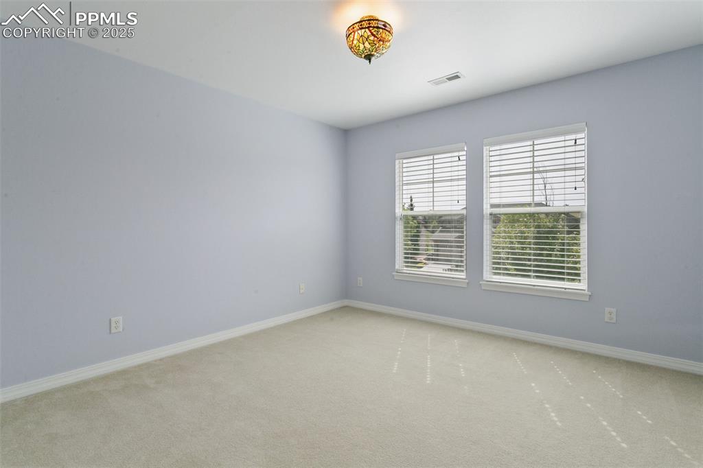 Image 25 of 37: Carpeted spare room with baseboards