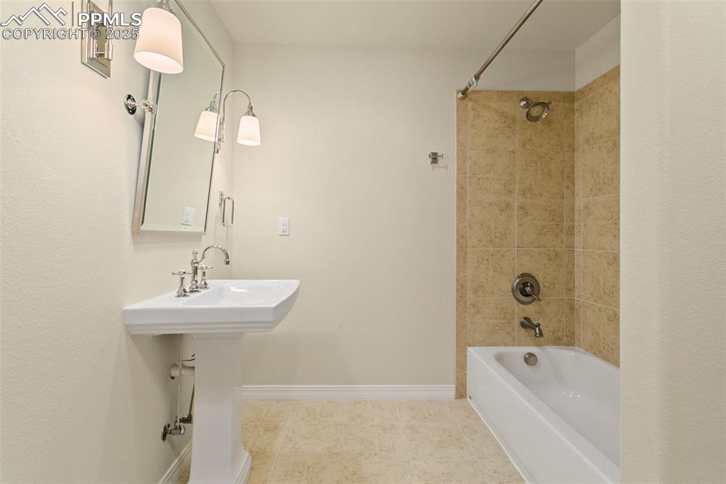 Image 27 of 37: Bathroom with shower / washtub combination and tile patterned flooring