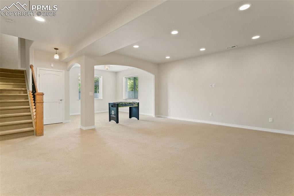 Image 29 of 37: Unfurnished living room with recessed lighting, arched walkways, light colo