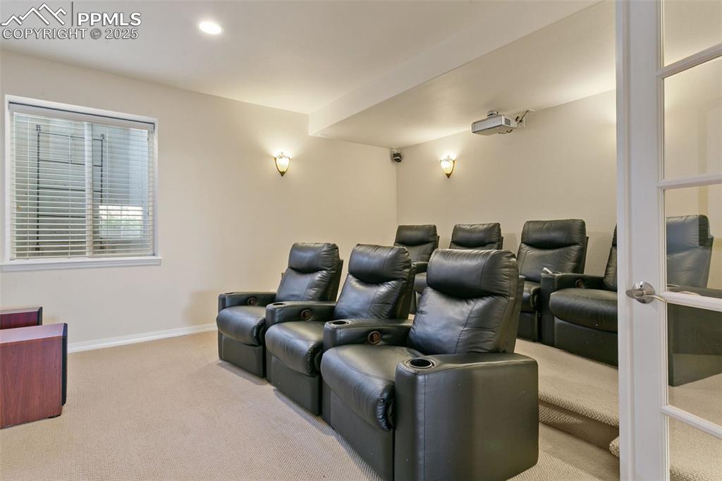 Image 31 of 37: Home theater with light colored carpet and recessed lighting