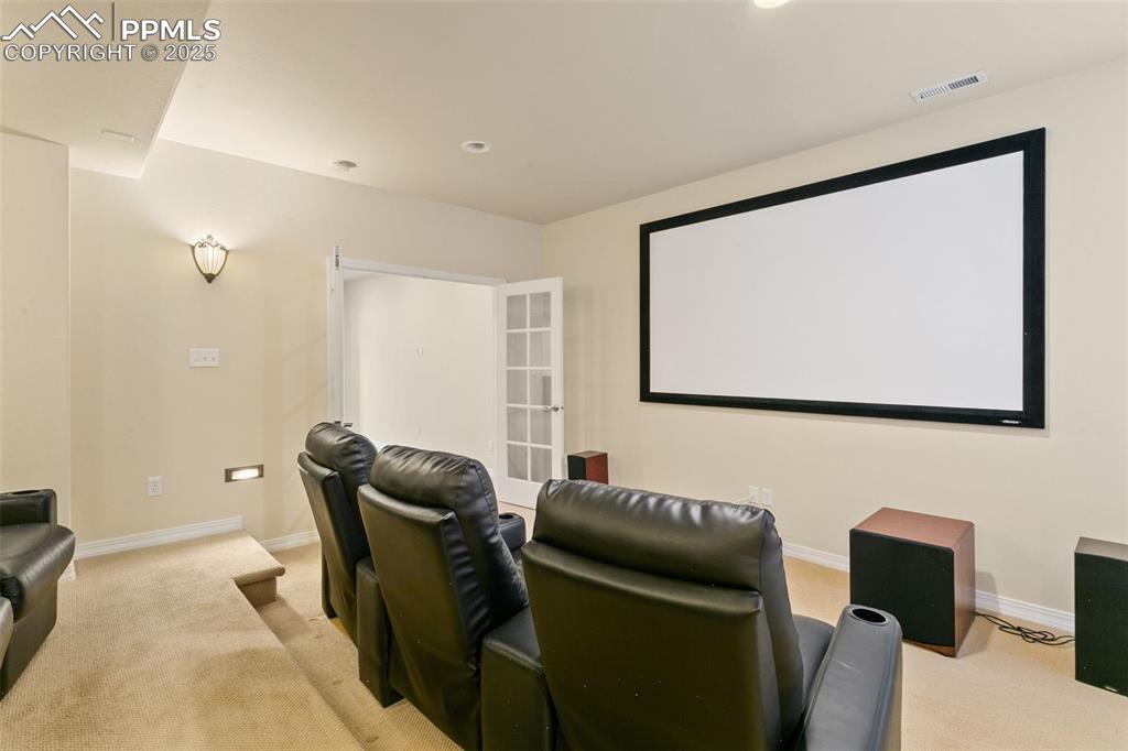Image 32 of 37: Home theater with light carpet and recessed lighting