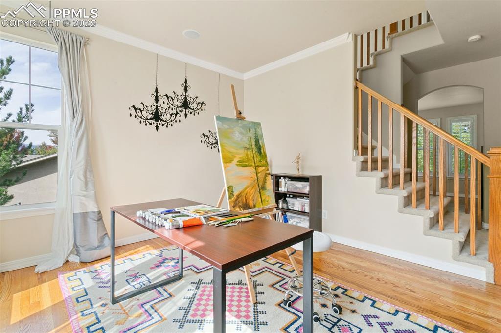 Image 9 of 37: Home office featuring light wood finished floors and ornamental molding