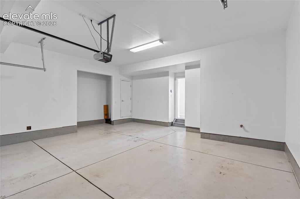 Image 14 of 33: Over sized 2 car garage with storage and a dog wash