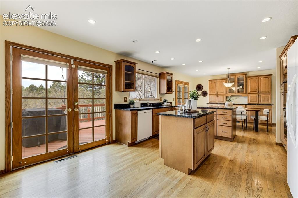 Image 13 of 38: French doors lead to the large deck (with stunning mountain views). 