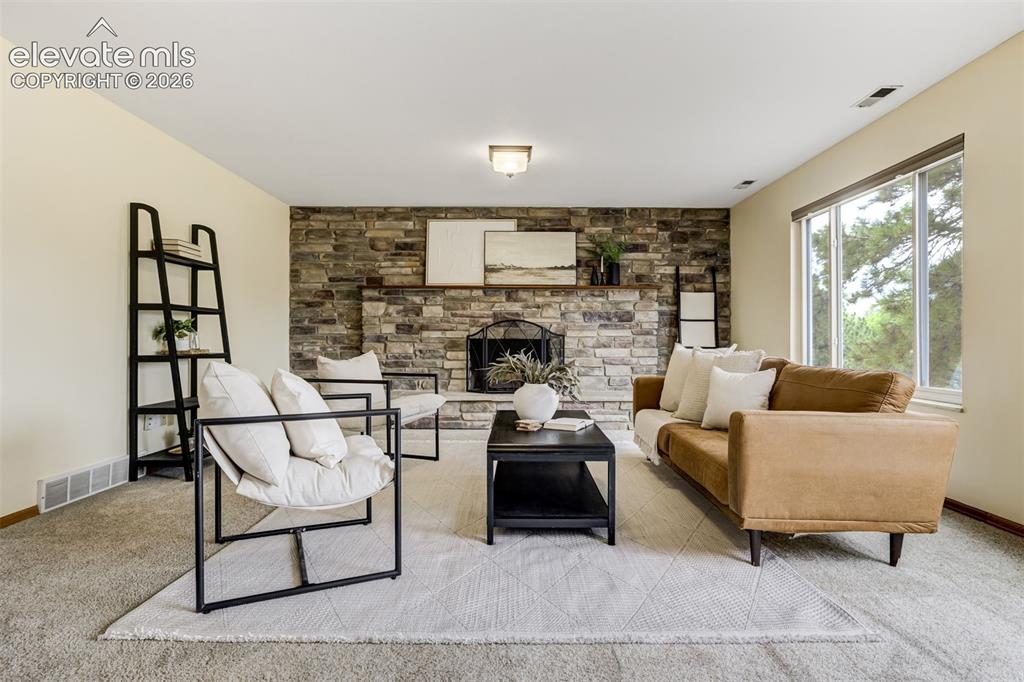 Image 16 of 38: Cozy fireplace, lower-level vibes, and enough room for everyone to “just ha