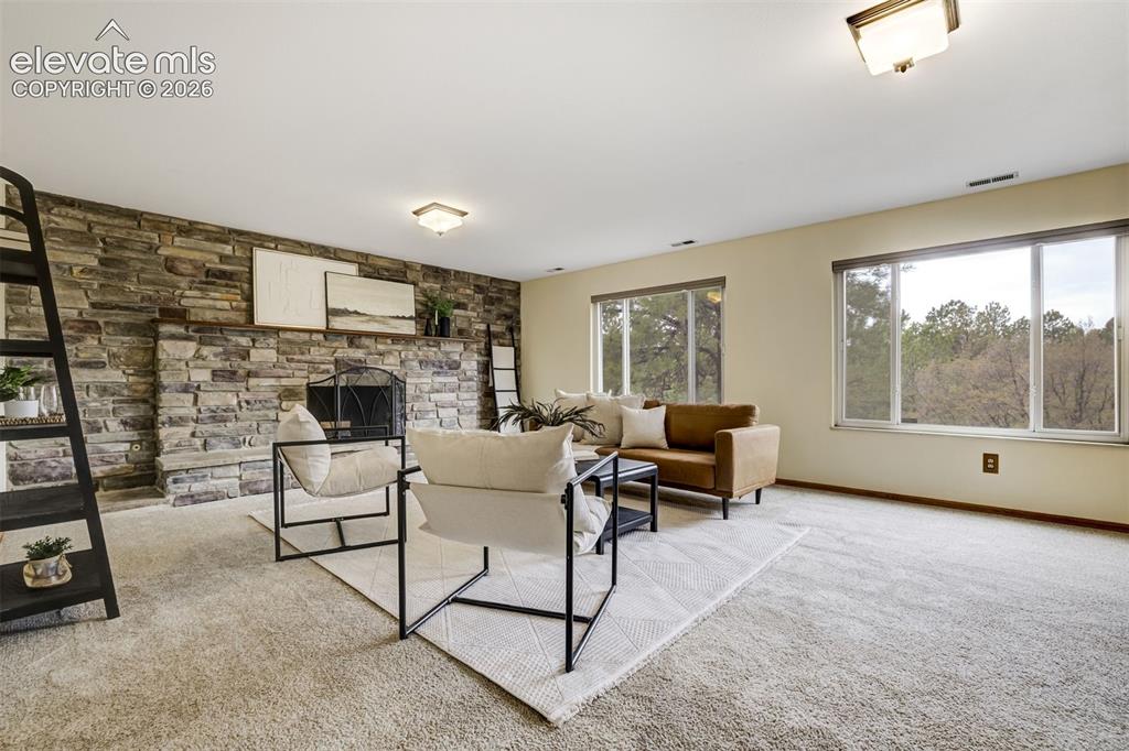 Image 17 of 38: Stone wall around the fireplace. 