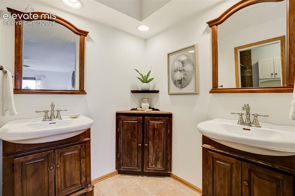 Image 27 of 38: Primary bedroom with a separate sinks so you don