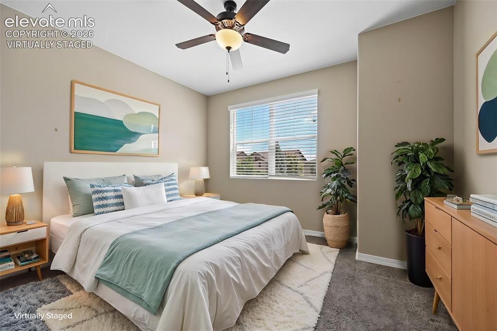 Image 13 of 37: Bedroom featuring neutral wall paint, a ceiling fan with light fixture, win