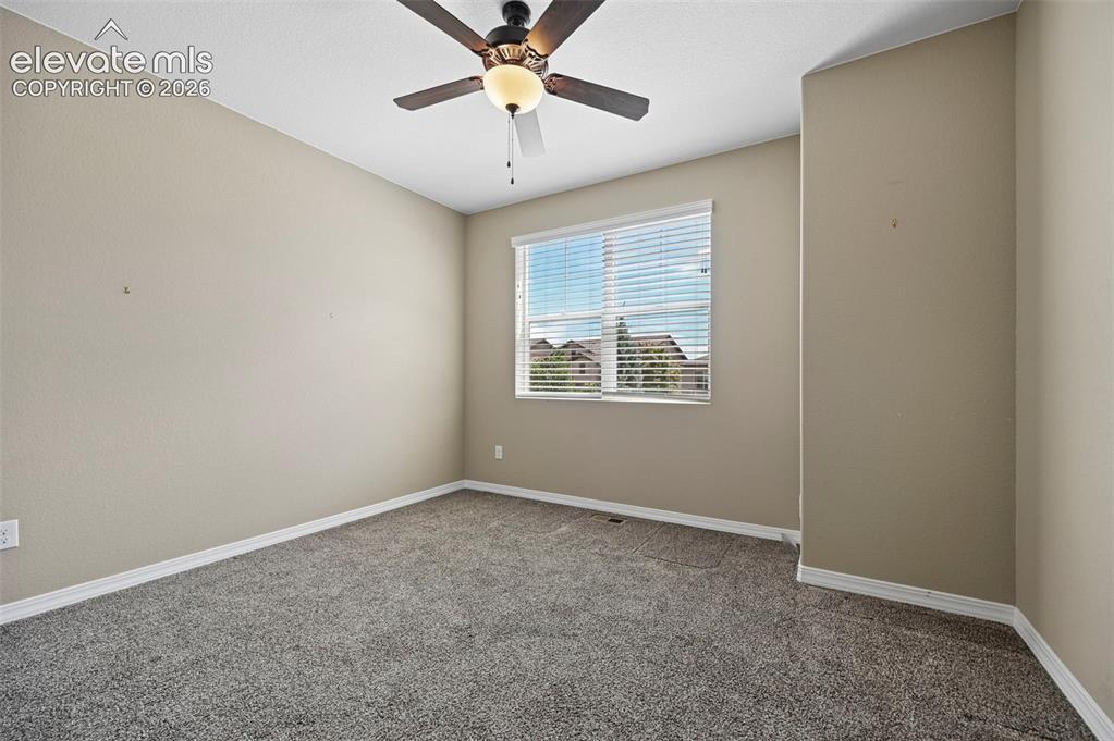 Image 14 of 37: Neutral tone walls with white trim and grey carpeting