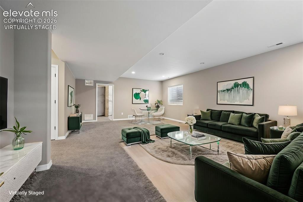 Image 18 of 37: Spacious room featuring neutral tone walls, recessed lighting, and carpet f