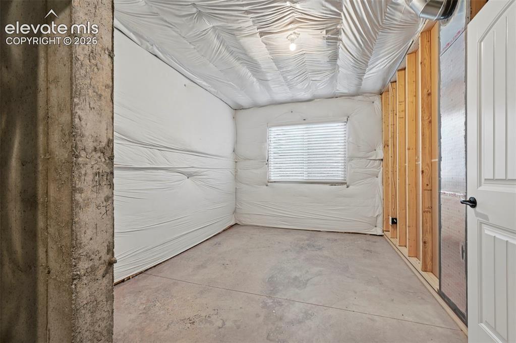 Image 20 of 37: Unfinished basement space featuring concrete flooring, exposed ceiling util