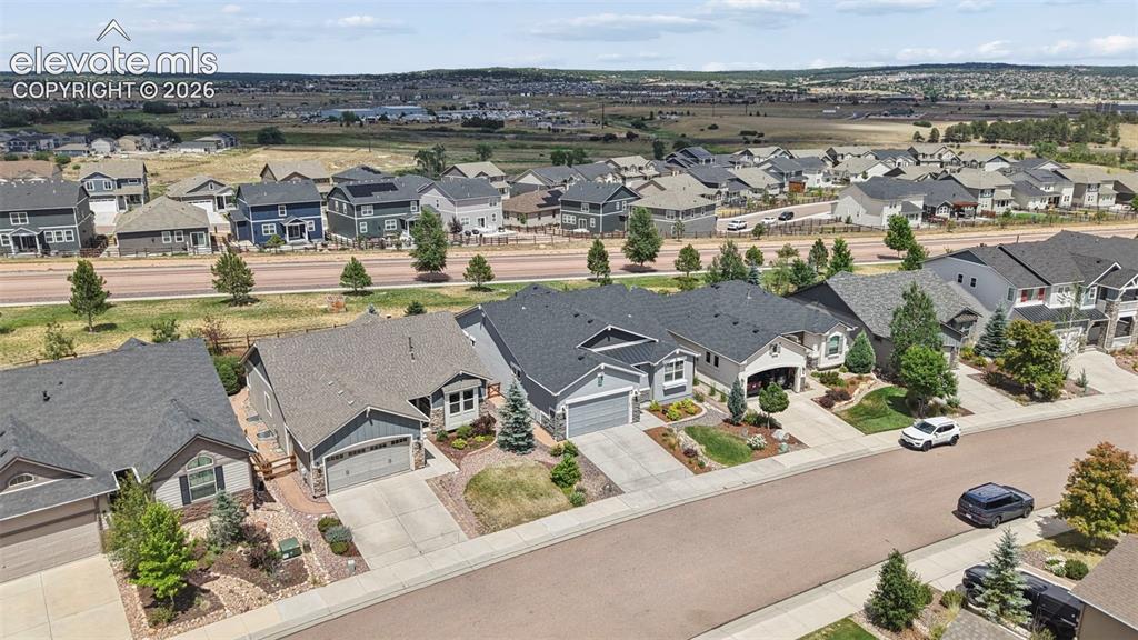 Image 28 of 37: Residential neighborhood featuring a paved street, established homes with g
