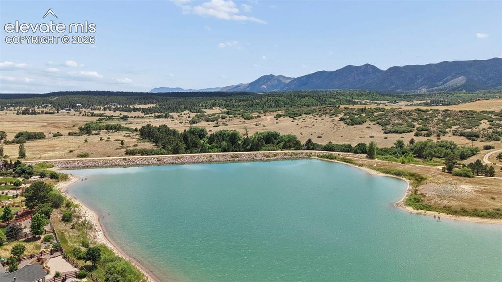 Image 31 of 37: Expansive reservoir with a natural shoreline, surrounded by rolling hills a