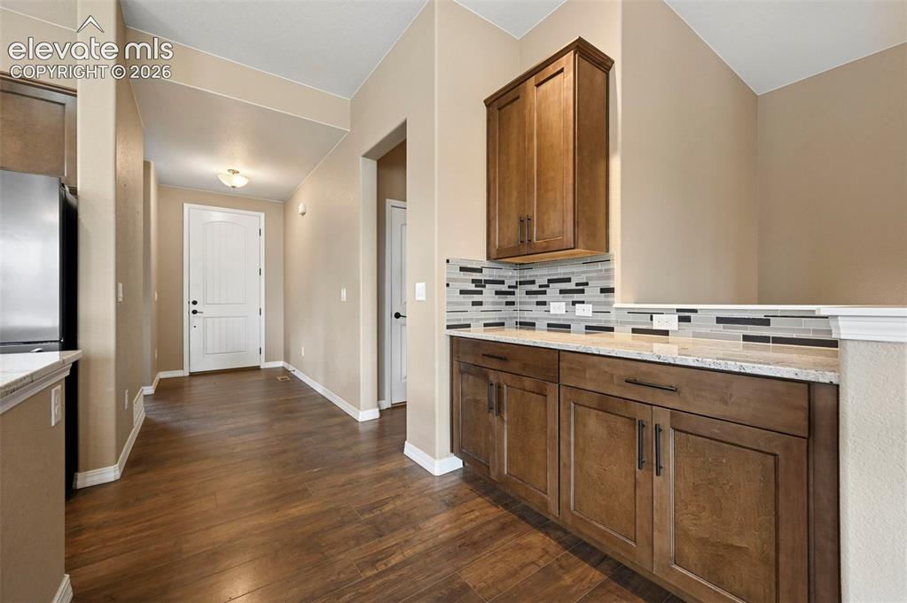 Image 5 of 37: Hall with dry bar off kitchen