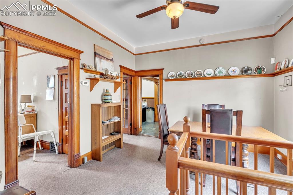 Image 14 of 49: Hallway featuring carpet floors and an upstairs landing