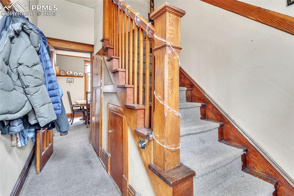 Image 29 of 49: Staircase with carpet and baseboards