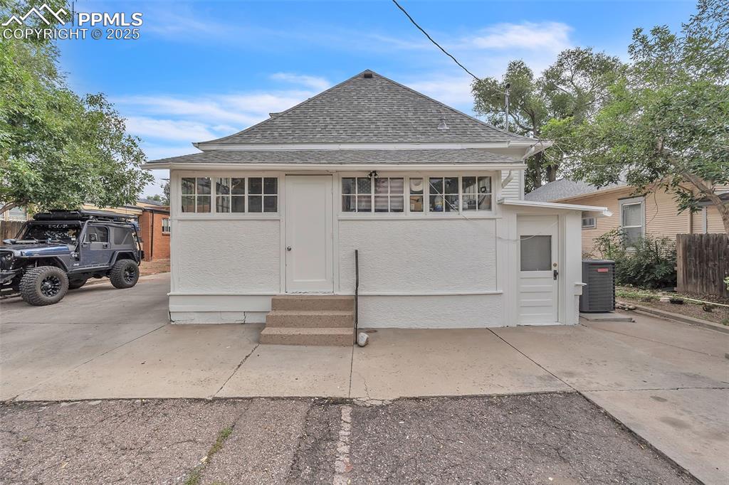 Image 36 of 49: View of front of home with roof with shingles and entry steps