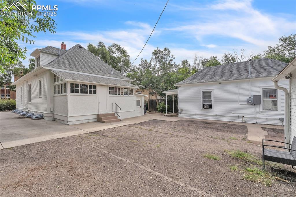 Image 39 of 49: Back of property with roof with shingles, a patio area, and entry steps