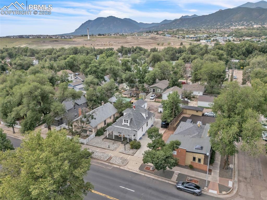 Image 45 of 49: Aerial perspective of suburban area with a mountainous background