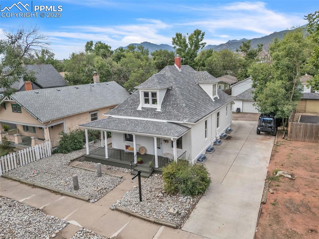 Image 46 of 49: Aerial view of property and surrounding area featuring a mountain backdrop
