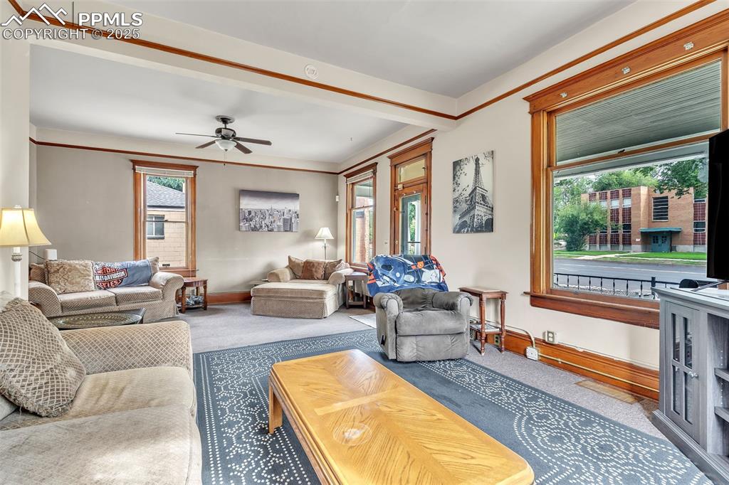 Image 9 of 49: Living area featuring carpet floors and a ceiling fan