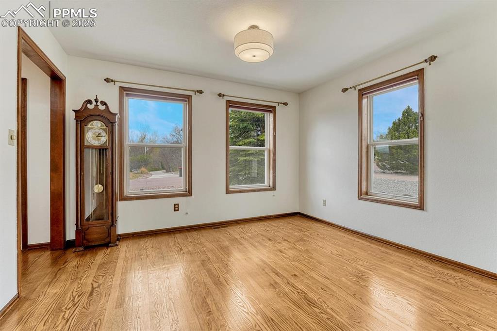 Image 10 of 44: Hardwood flooring with natural wood-tone trim and baseboards
