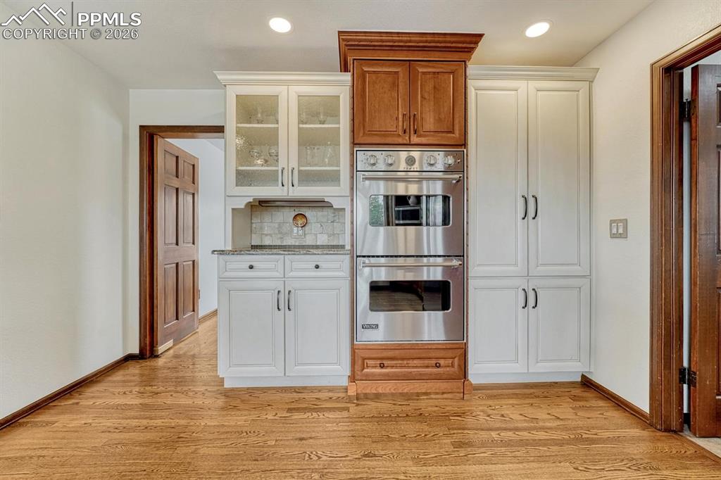 Image 13 of 44: Built-in double ovens with stainless steel finish, integrated into custom c