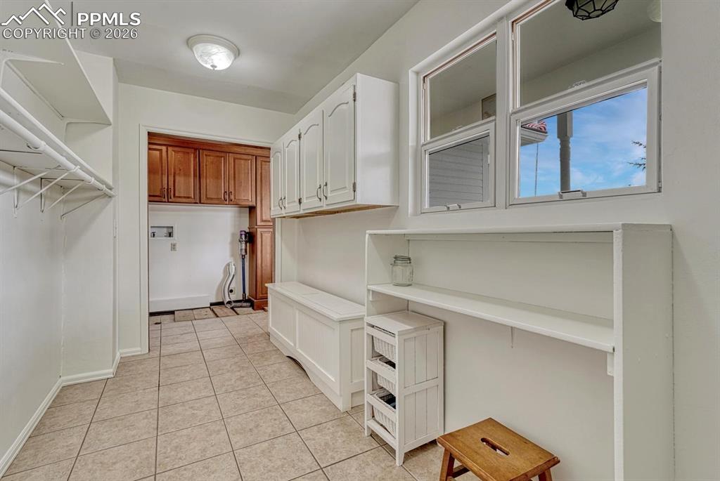 Image 20 of 44: Utility room with tiled flooring and white walls