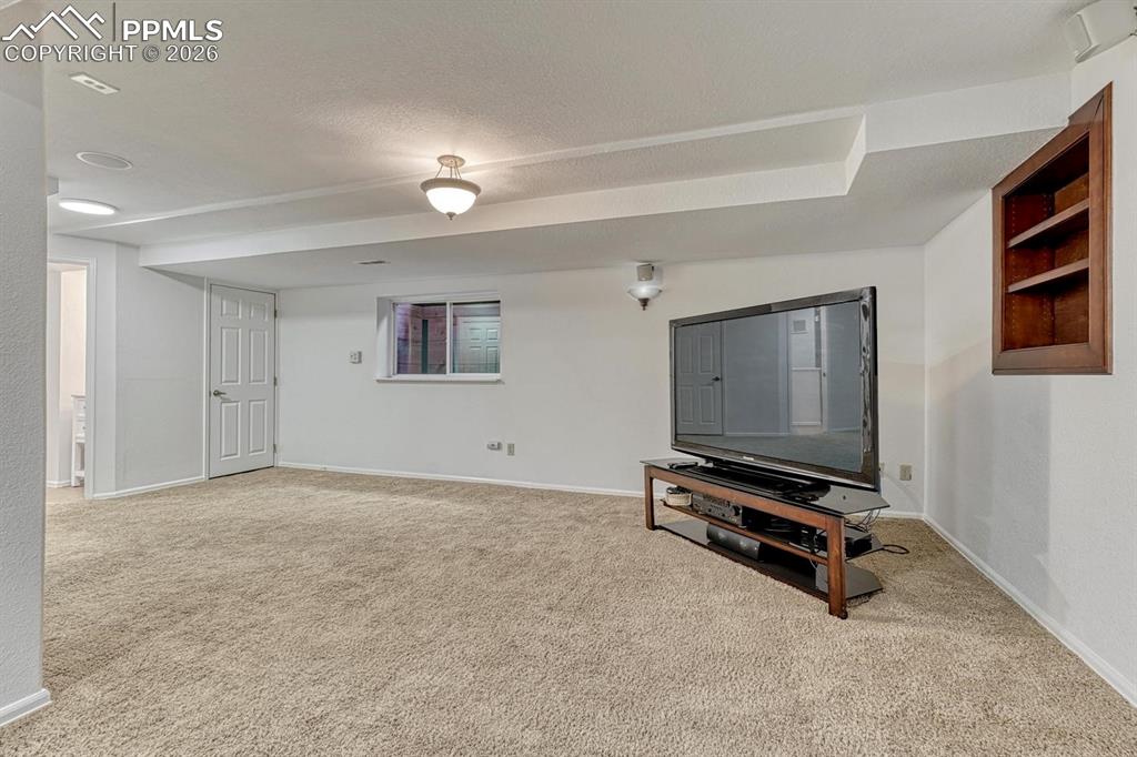 Image 37 of 44: Carpeted recreation room featuring recessed lighting, a built-in wall cabin