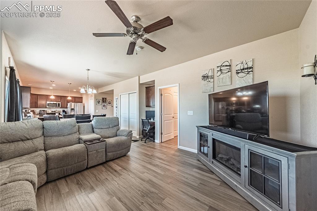 Image 14 of 33: Living room featuring wood finished floors and ceiling fan