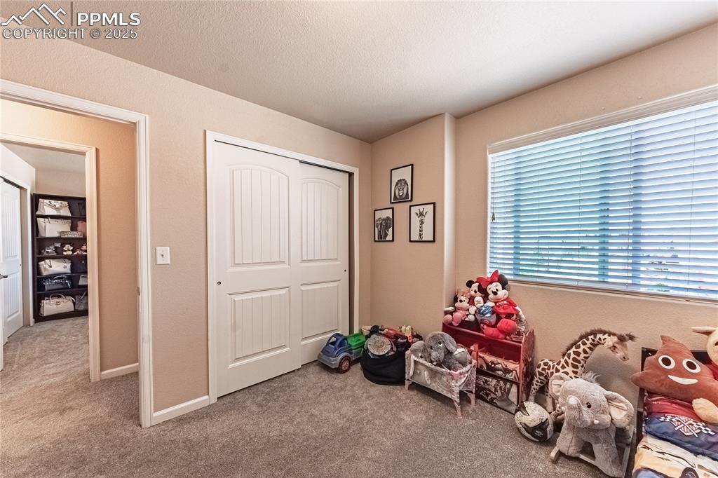 Image 21 of 33: Playroom featuring light colored carpet