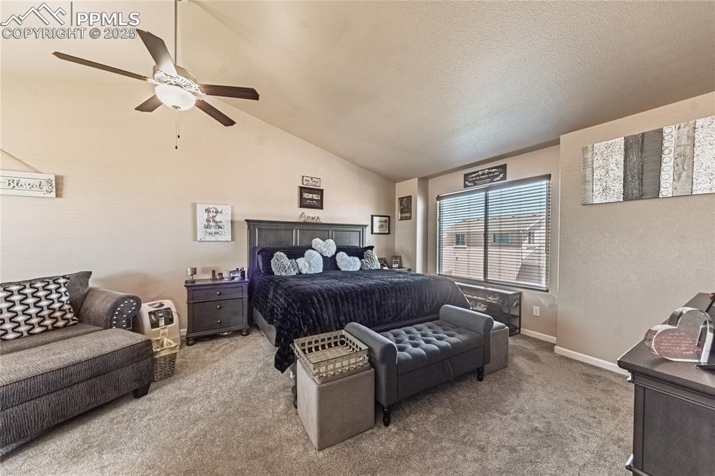 Image 26 of 33: Bedroom featuring carpet flooring, vaulted ceiling, and ceiling fan