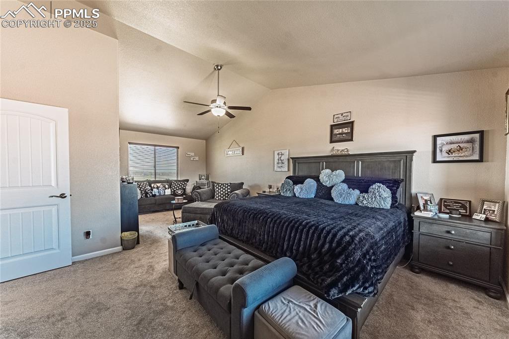 Image 27 of 33: Carpeted bedroom featuring lofted ceiling and a ceiling fan