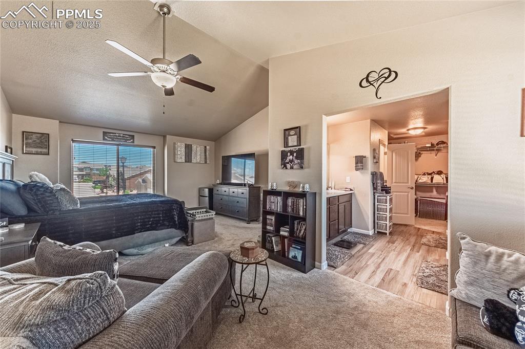 Image 29 of 33: Bedroom featuring light colored carpet, ensuite bathroom, light wood-type f