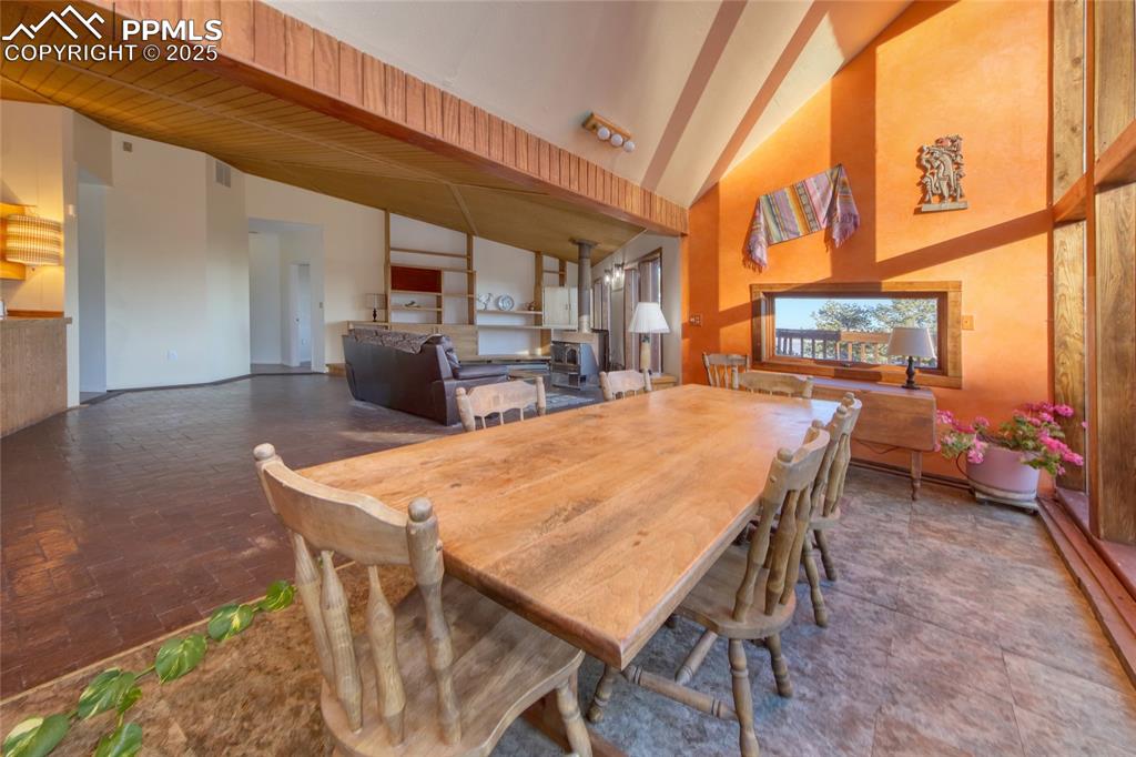 Image 11 of 33: Dining room featuring beamed ceiling, visible vents, and high vaulted ceili