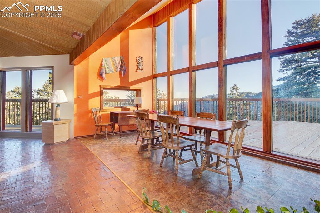 Image 12 of 33: Dining area featuring a healthy amount of sunlight, high vaulted ceiling, w