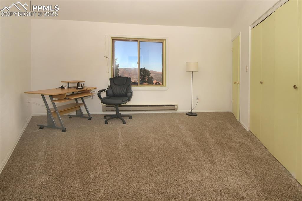 Image 14 of 33: Carpeted Bedroom 3 featuring baseboards and a baseboard radiator