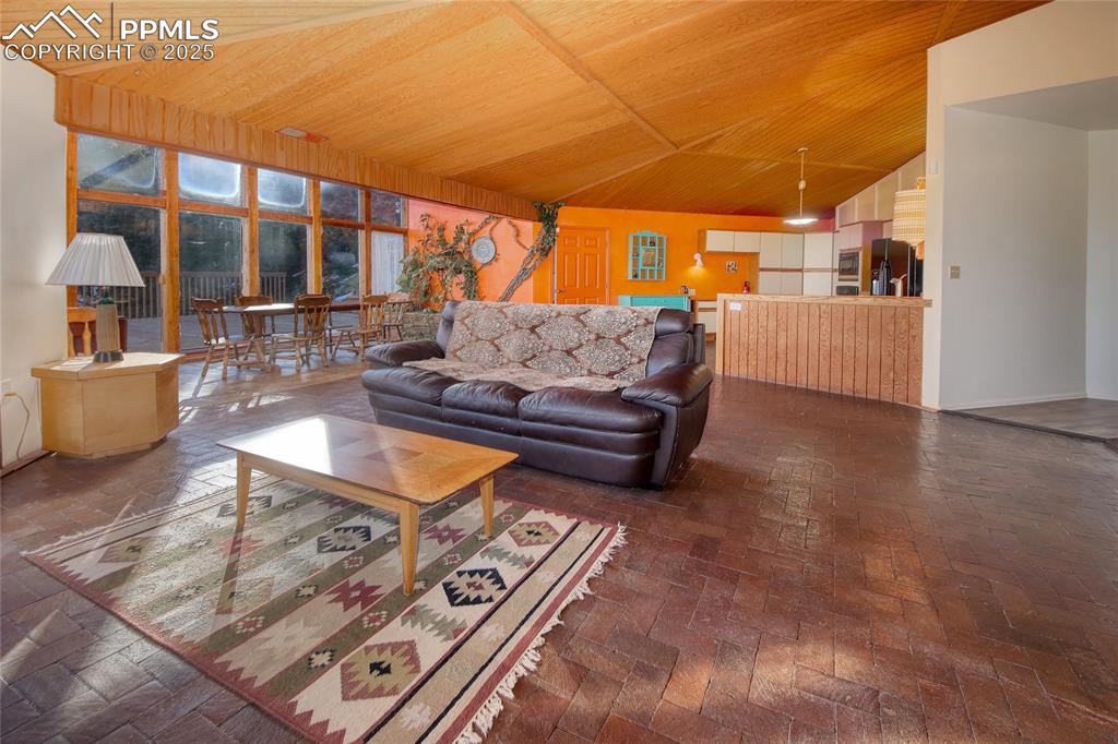 Image 7 of 33: Living room facing passive solar sunroom