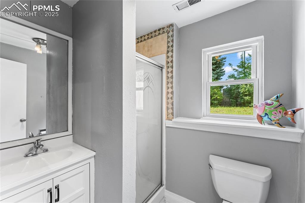 Image 11 of 21: Bathroom featuring a stall shower and vanity