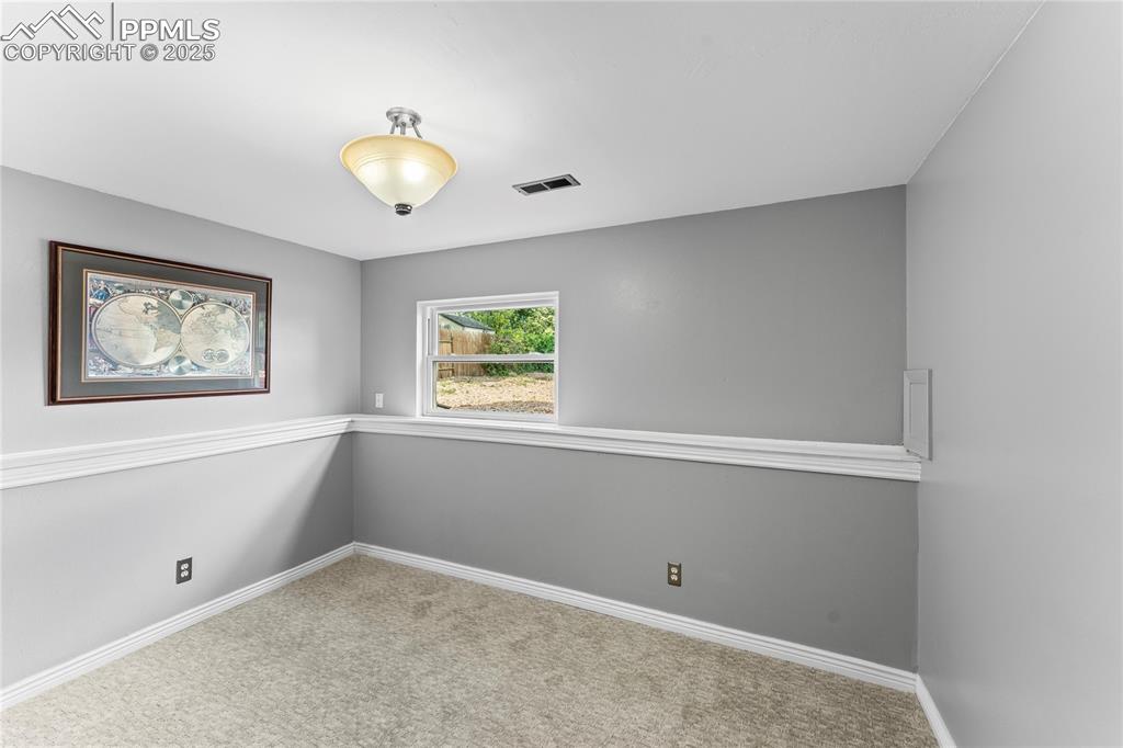 Image 12 of 21: Large, lower level bedroom adjacent to 3/4 bath