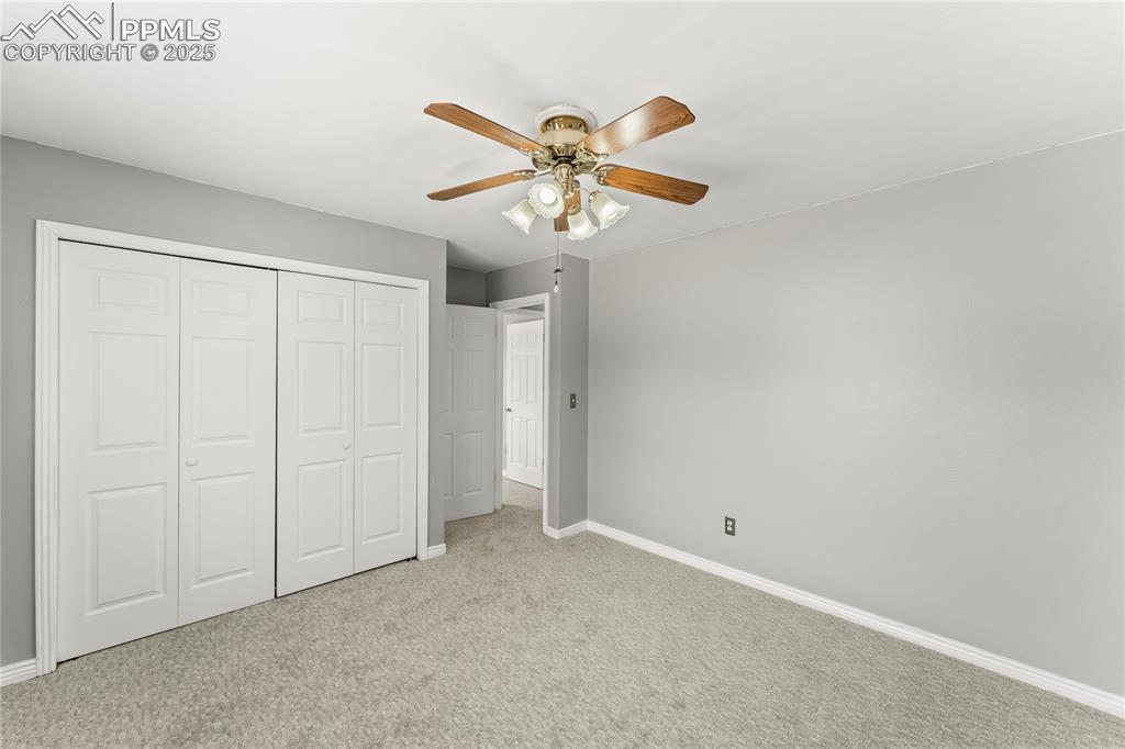 Image 17 of 21: Unfurnished bedroom featuring a closet, carpet, and ceiling fan