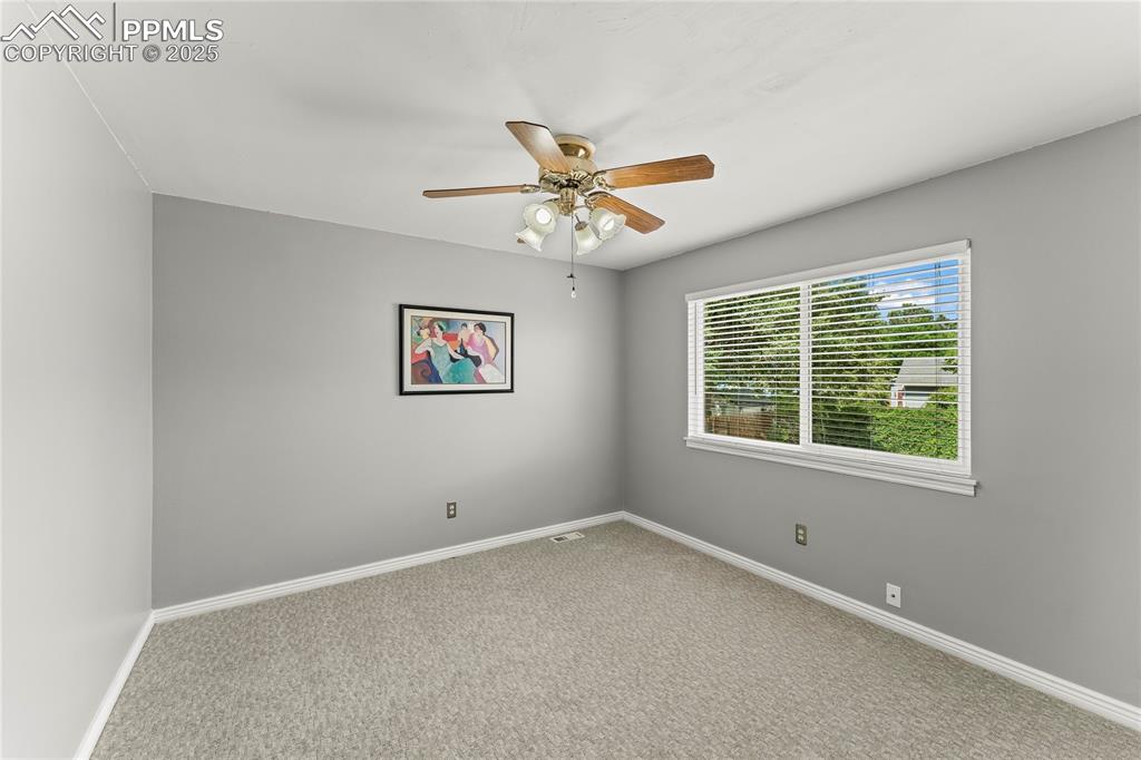 Image 18 of 21: Empty room featuring ceiling fan and carpet