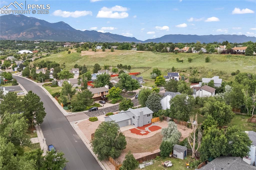Image 19 of 21: Aerial view of residential area with a mountain backdrop