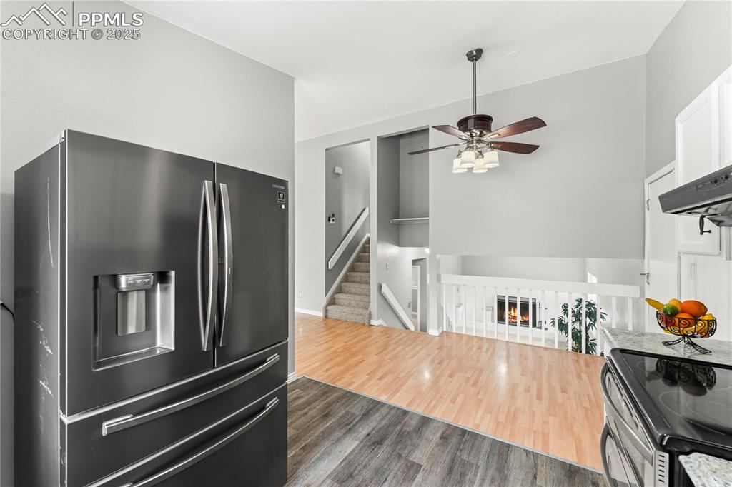Image 6 of 21: Kitchen featuring stainless steel fridge with ice dispenser, ceiling fan, d