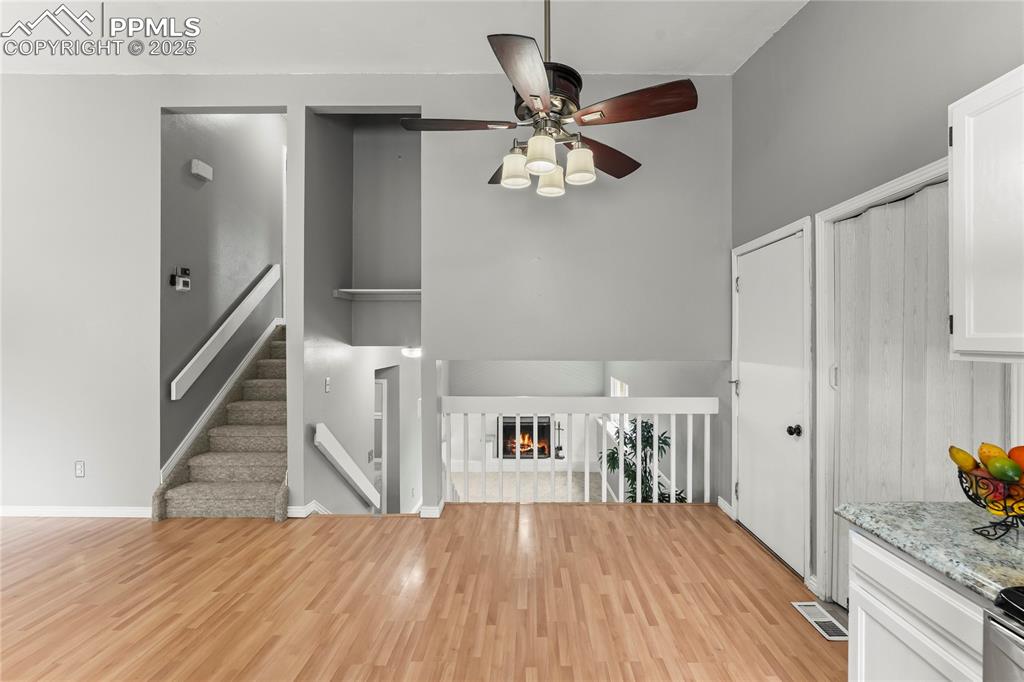 Image 7 of 21: Center of home overlooking family room and access to upper level